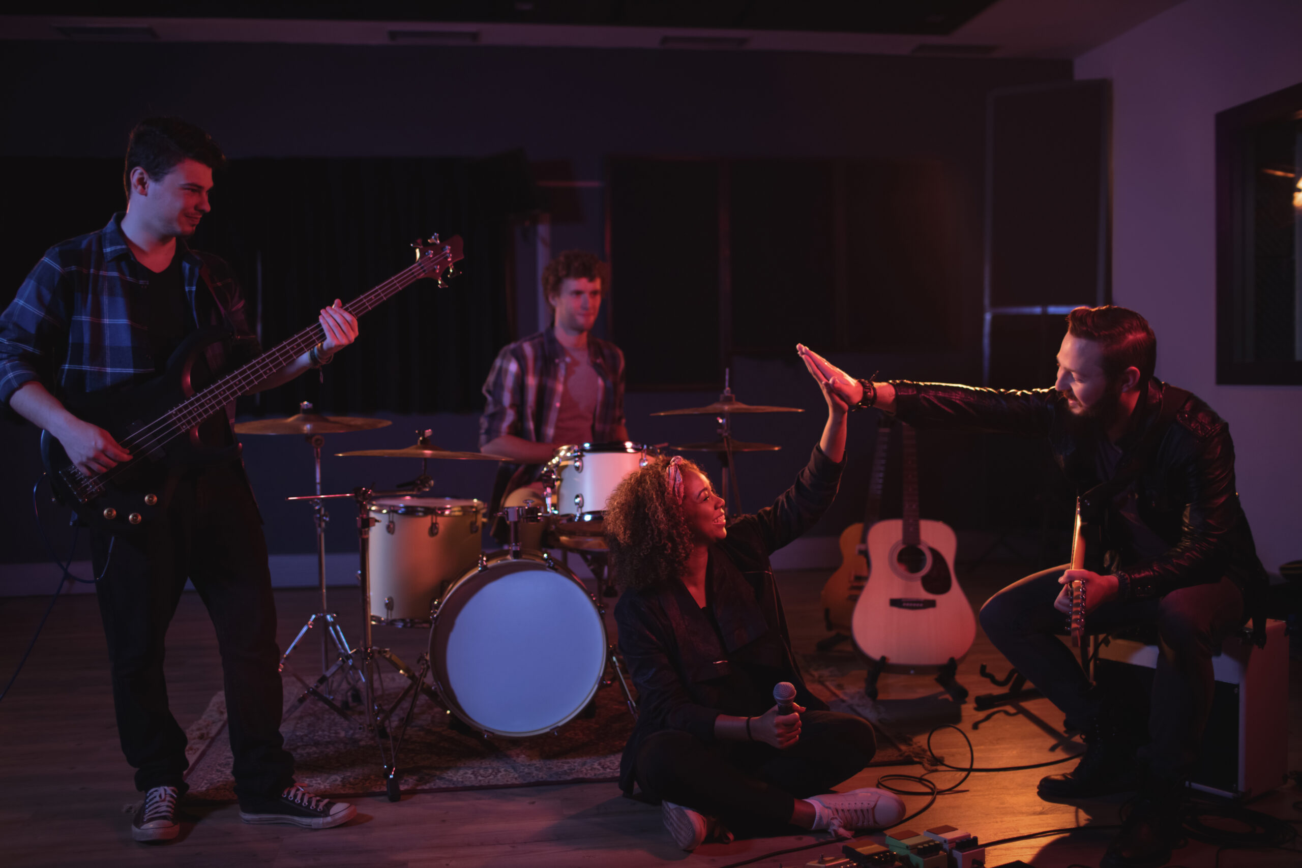 Band mates giving high five to each other in recording studio
