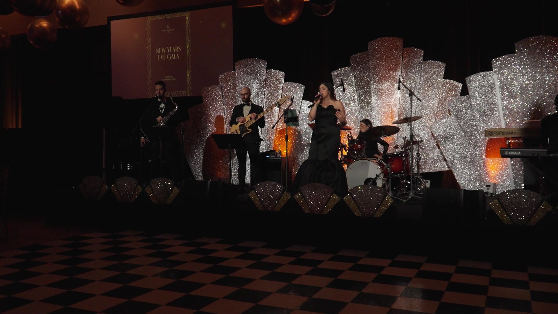 Art Deco room design with silver sunburst backdrop, checkered dance floor, and Sunny Jazz Band on stage