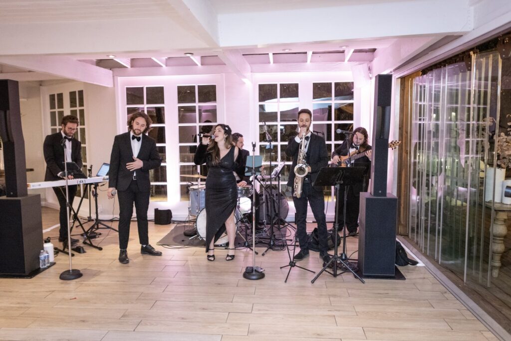 Sunny Jazz Band 6 piece corporate function band with two vocalists, keys, bass, drums, and saxophone performing at an elegant Los Angeles venue